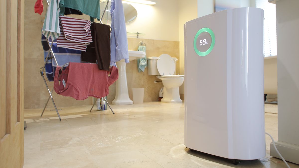 dehumidifier drying clothes in utility room