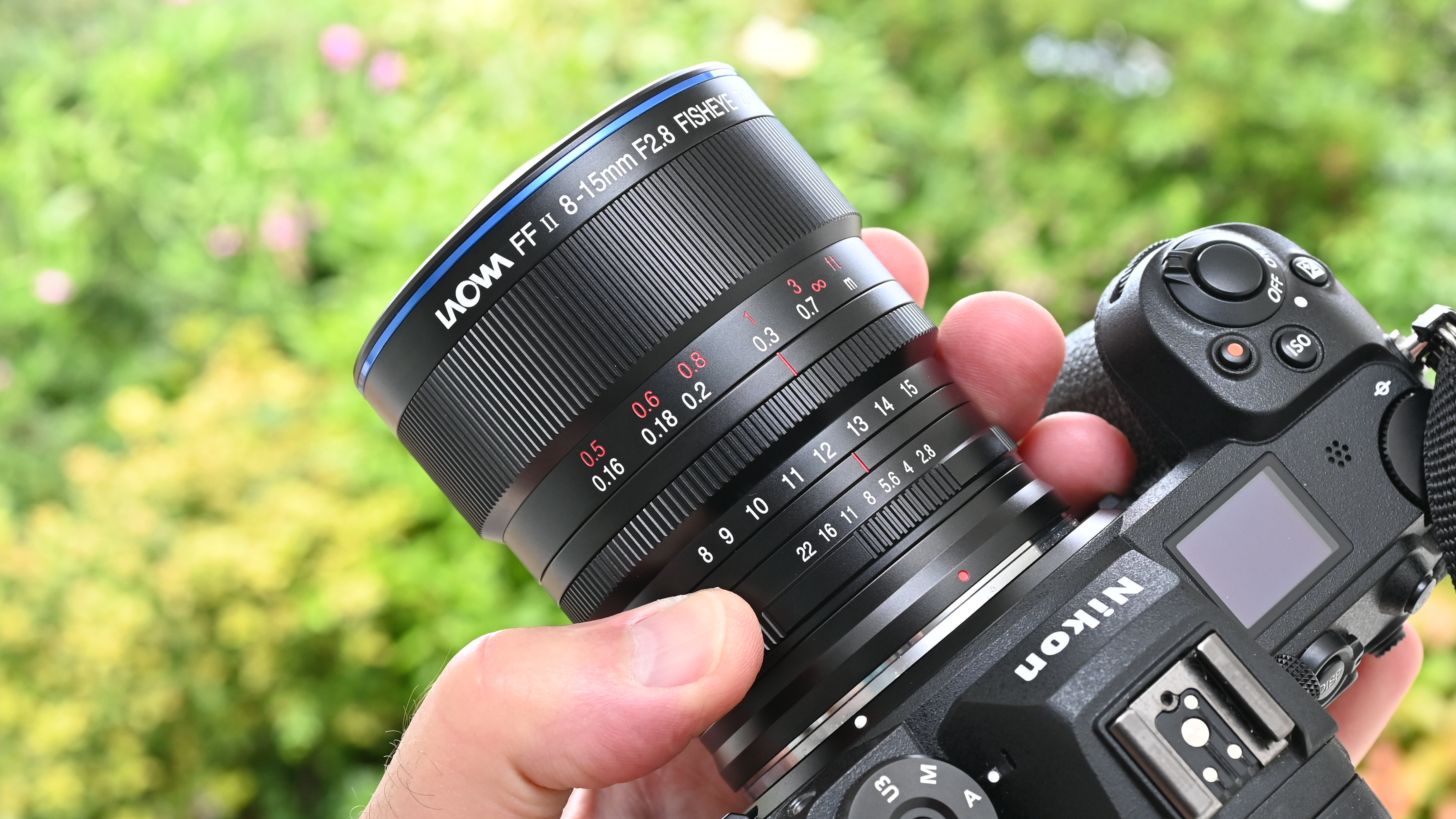 Laowa 8-15mm f/2.8 FF Zoom Fisheye product image of lens held in hand
