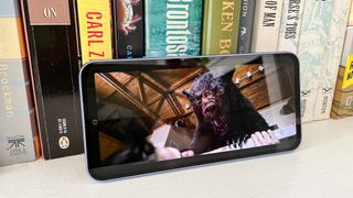 The bear growls in Cocaine Bear on the Samsung Galaxy A54, in front of books