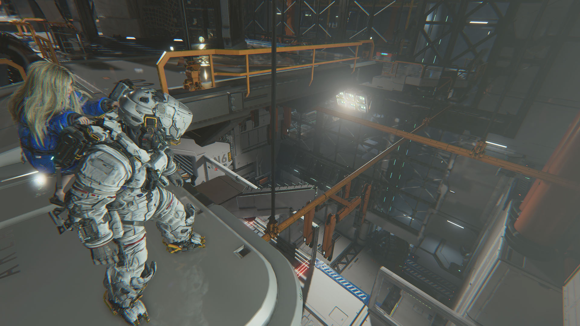 Hugh and Diana look down at a facility that spans below the walkway they are on in Pragmata