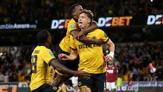 Jorgen Strand Larsen of Wolverhampton Wanderers celebrates scoring his team's third goal with teammates Jackson Tchatchoua and Jhon Arias during the Carabao Cup Second Round match between Wolverhampton Wanderers and West Ham United at Molineux on August 26, 2025 in Wolverhampton, England. 
