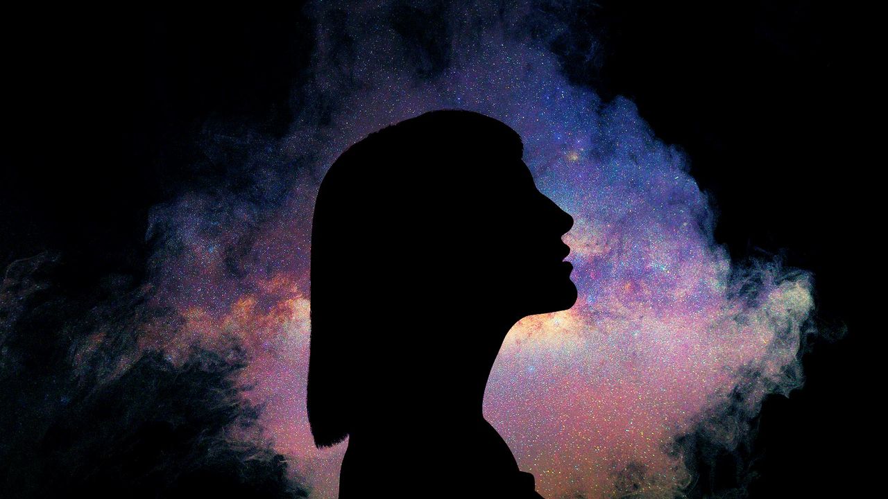 Woman&#039;s silhouette against a galaxy background