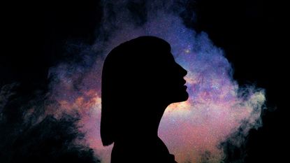 Woman's silhouette against a galaxy background