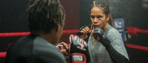 Halle Berry raises her hands in the ring at practice in Bruised.