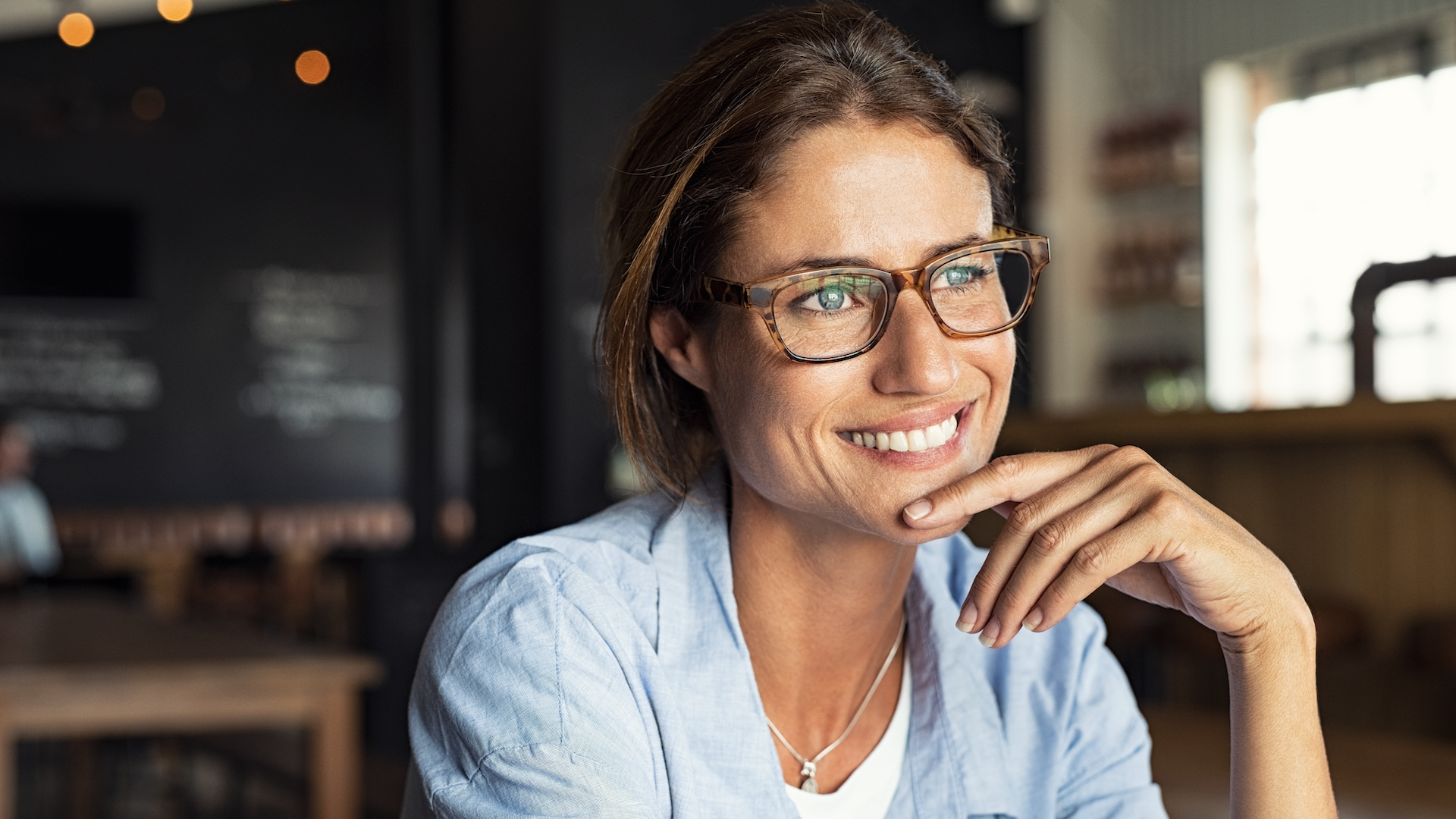 Woman wearing glasses and looking in distance