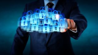 Man in suit pressing padlocks in the shape of a cloud