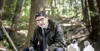Alfred Molina as Armand Gamache at a crime scene in the woods in Three Pines