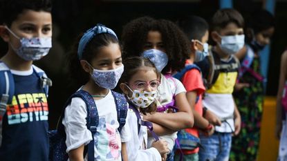 Elementary school students wearing masks.