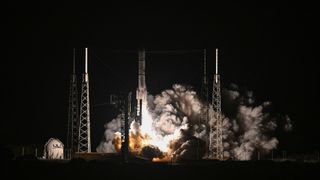 A glowing rocket launch against a dark sky