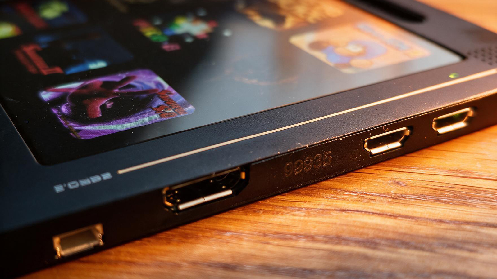 A small black gaming handheld in a wooden table