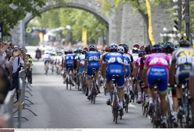 The riders approach the finish/start line and get ready for another lap