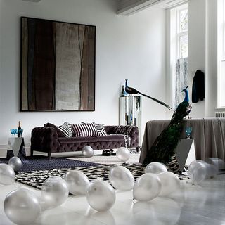 living room with white wall and peacock statue