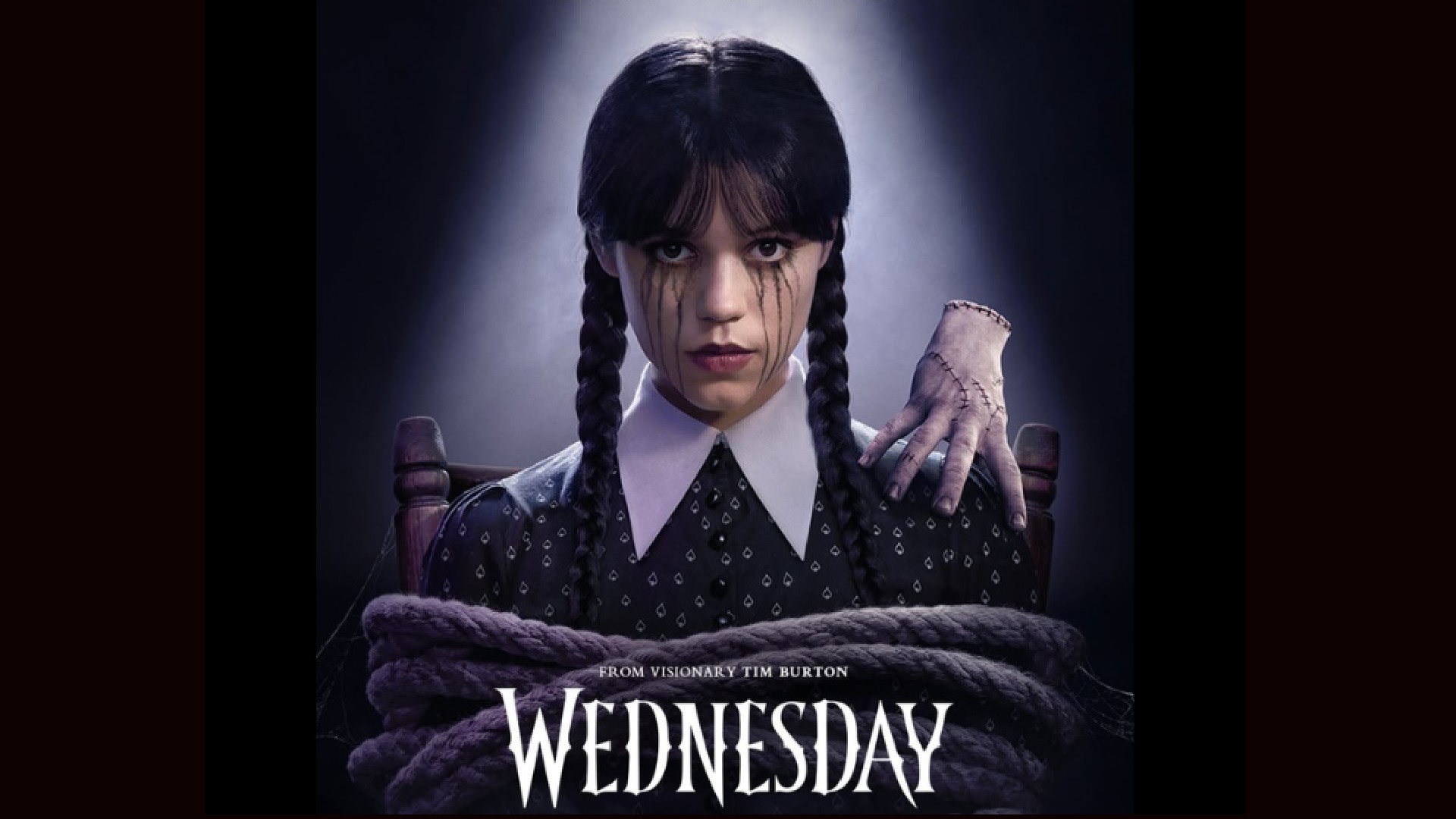 A poster for the show &quot;Wednesday&quot; shows the main character, with her hands tied, looking at the viewer.