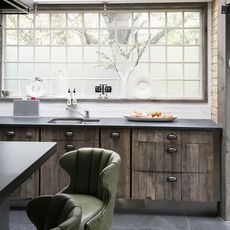 kitchen with wooden drawers and windows