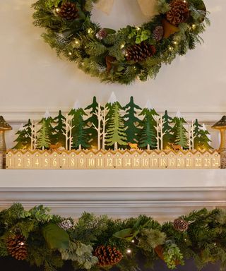 Christmas mantel with green wreath, garland and advent display