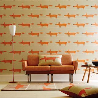 living room with orange fox designed wall orange sofa with orange fox designed cushion