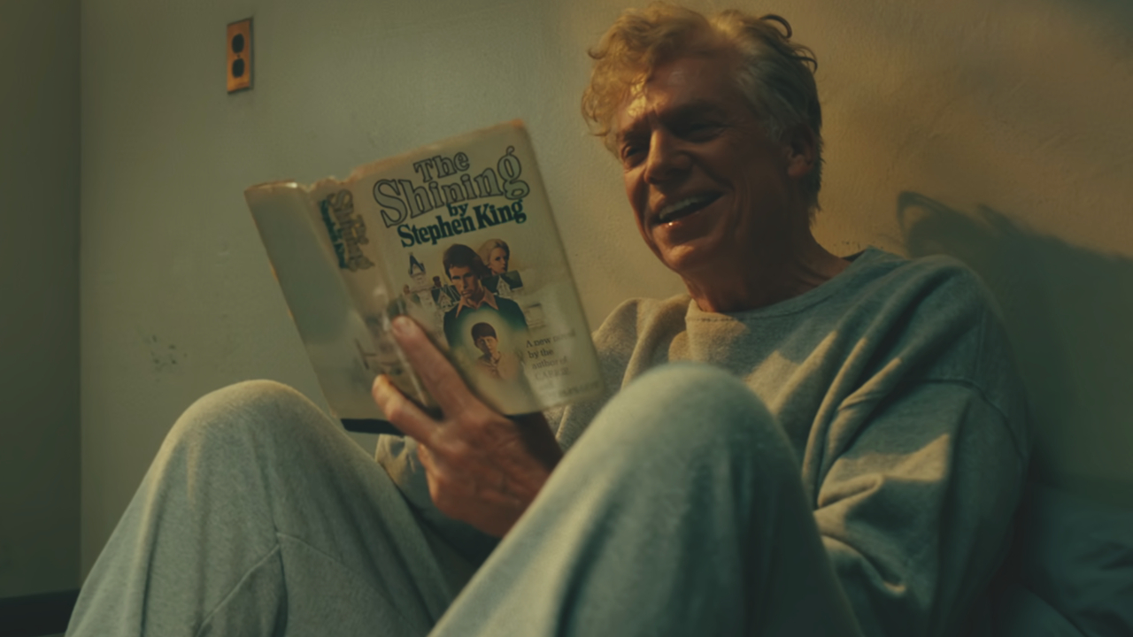 Christopher McDonald laughs in his room while reading The Shining in Happy Gilmore 2.