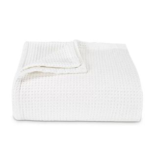 A white textured folded blanket