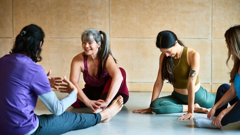 Image of yoga class with varying ages of women