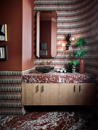 modern bathroom with red and white tiles and the pattern repeated in the vanity countertop