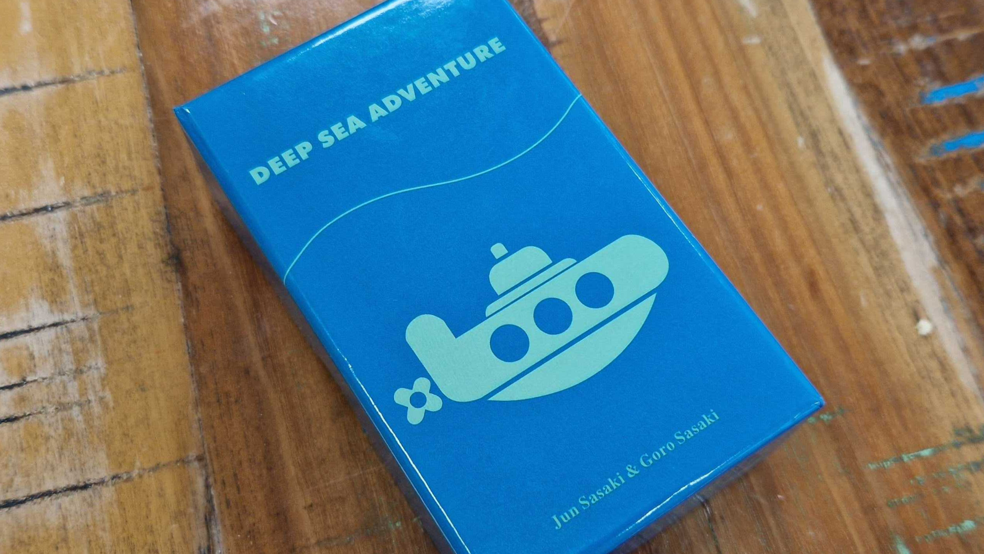 Deep Sea Adventure box on a wooden table