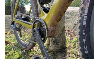 The Scott Solace Gravel eRide 10 image is of the underneath of the down tube drive train and rear wheel splattered with mud