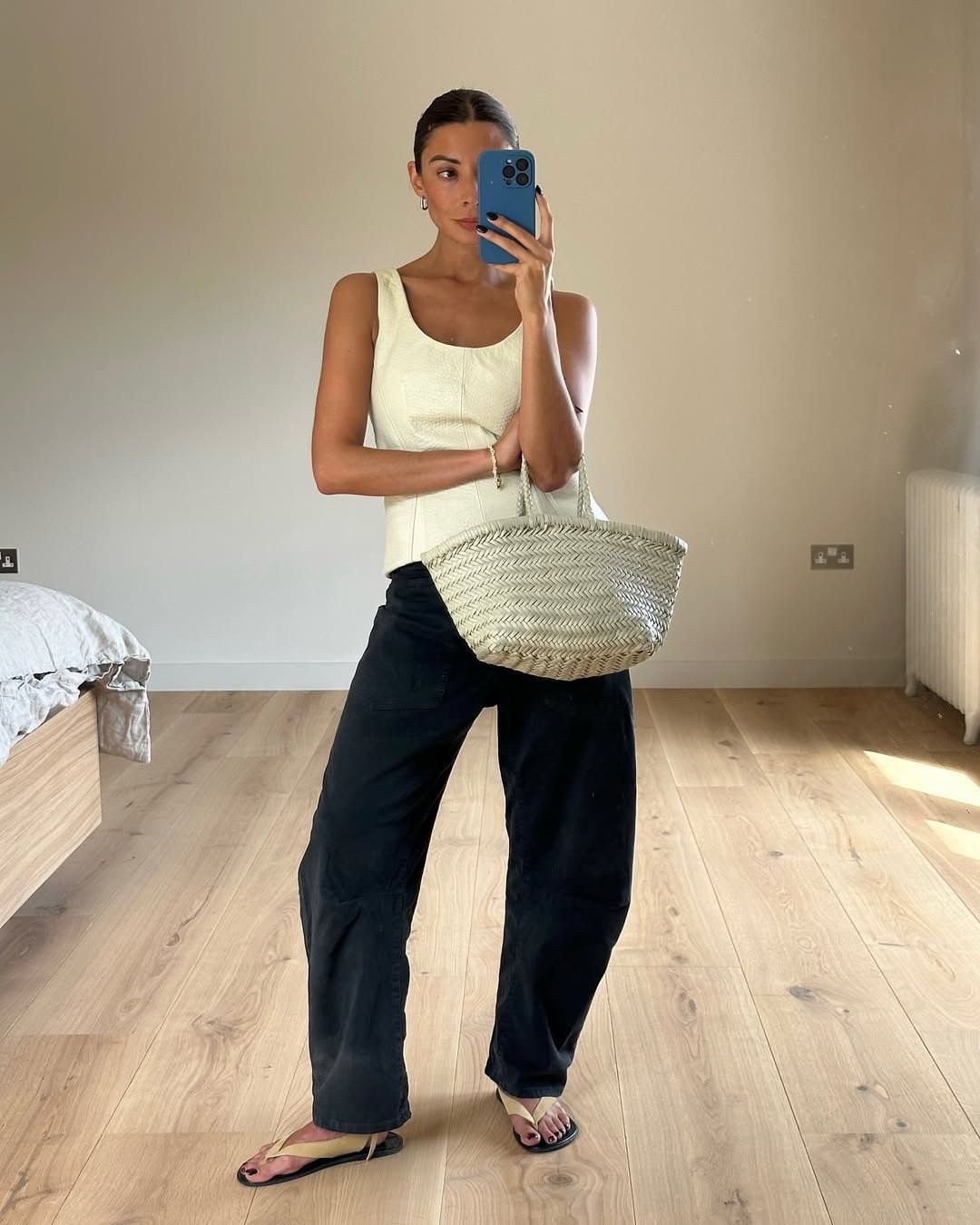 @smythsisters wears a cream leather woven tote