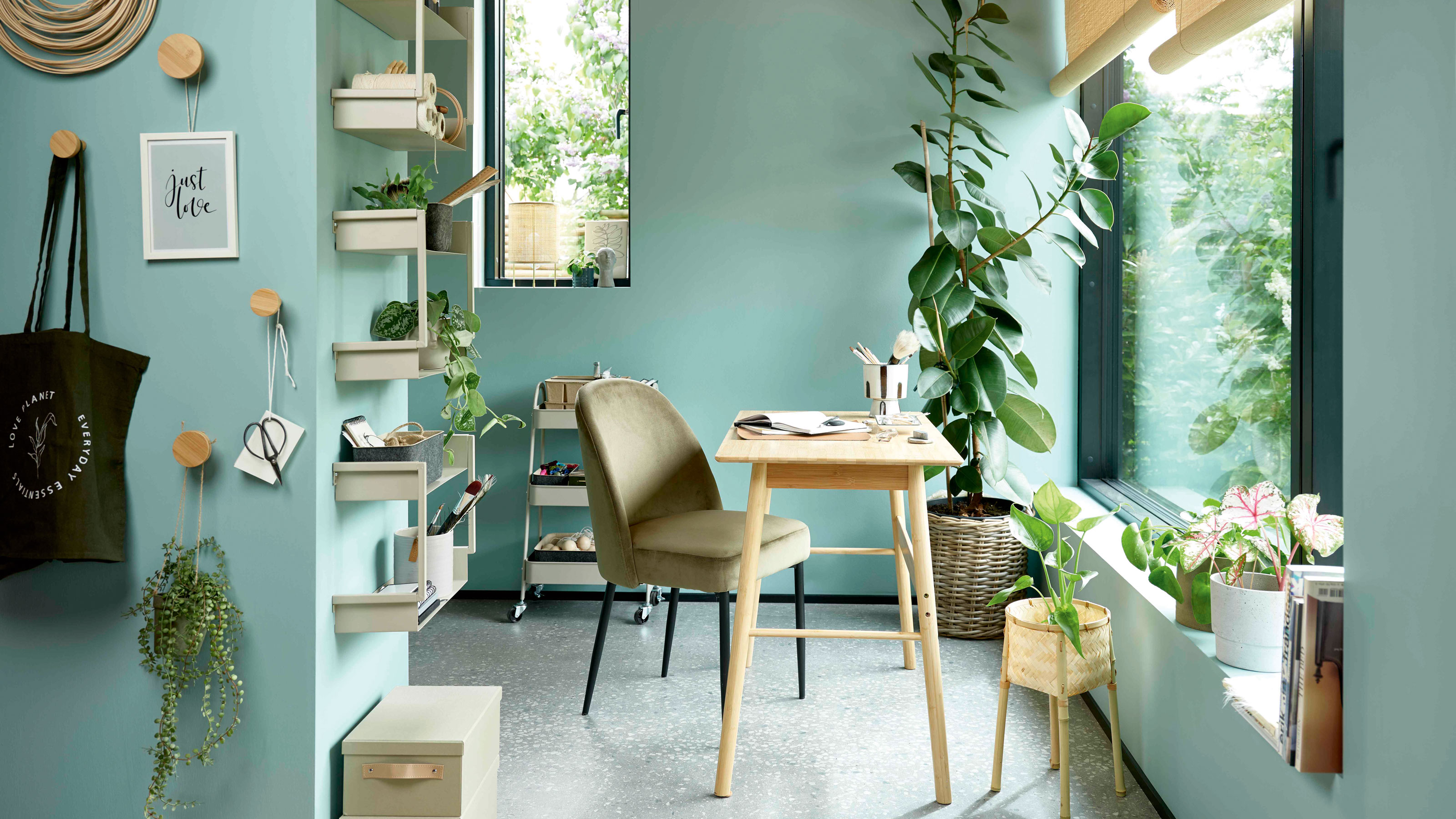 Blue home office, wooden desk and houseplants