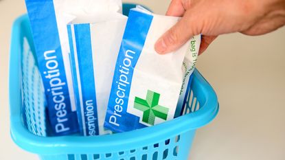 Three bags of prescriptions in a blue basket