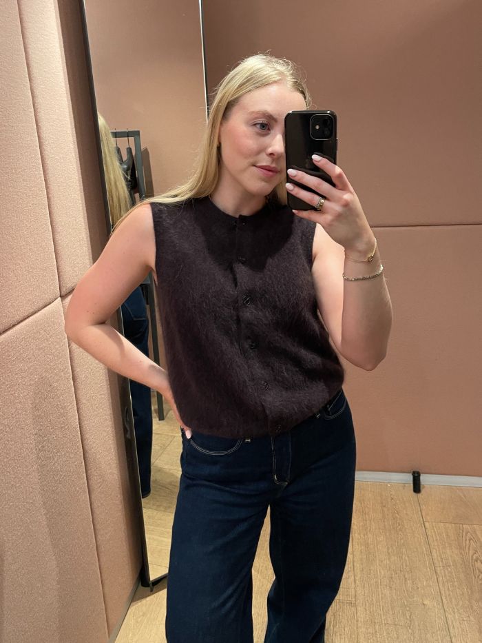 Woman wears brown brushed cashmere waistcoat and blue jeans