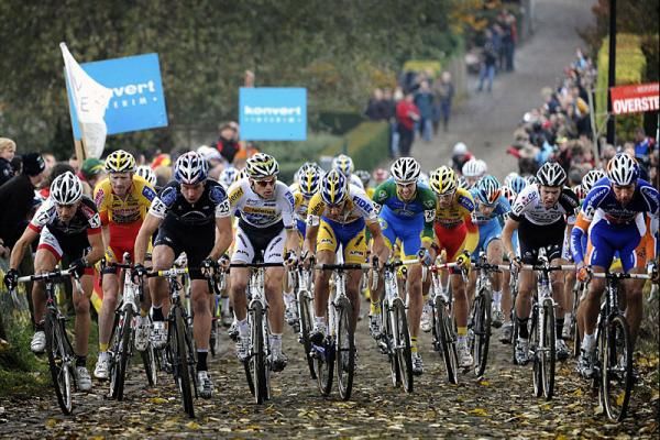 The elite men charge up the cobbled Koppenberg on the opening lap.