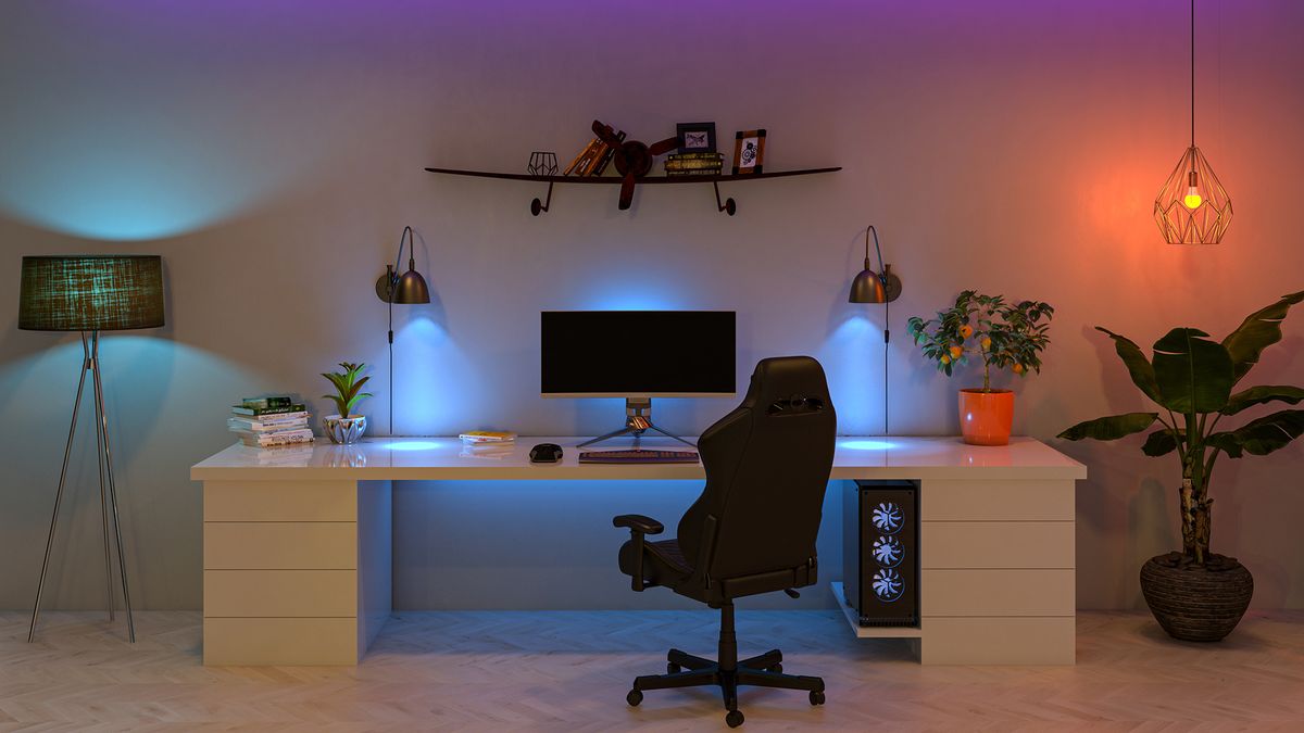 A photograph of a desk in a home office with a monitor and PC 