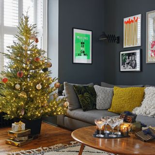 Decorated real Christmas tree inside furnished living room