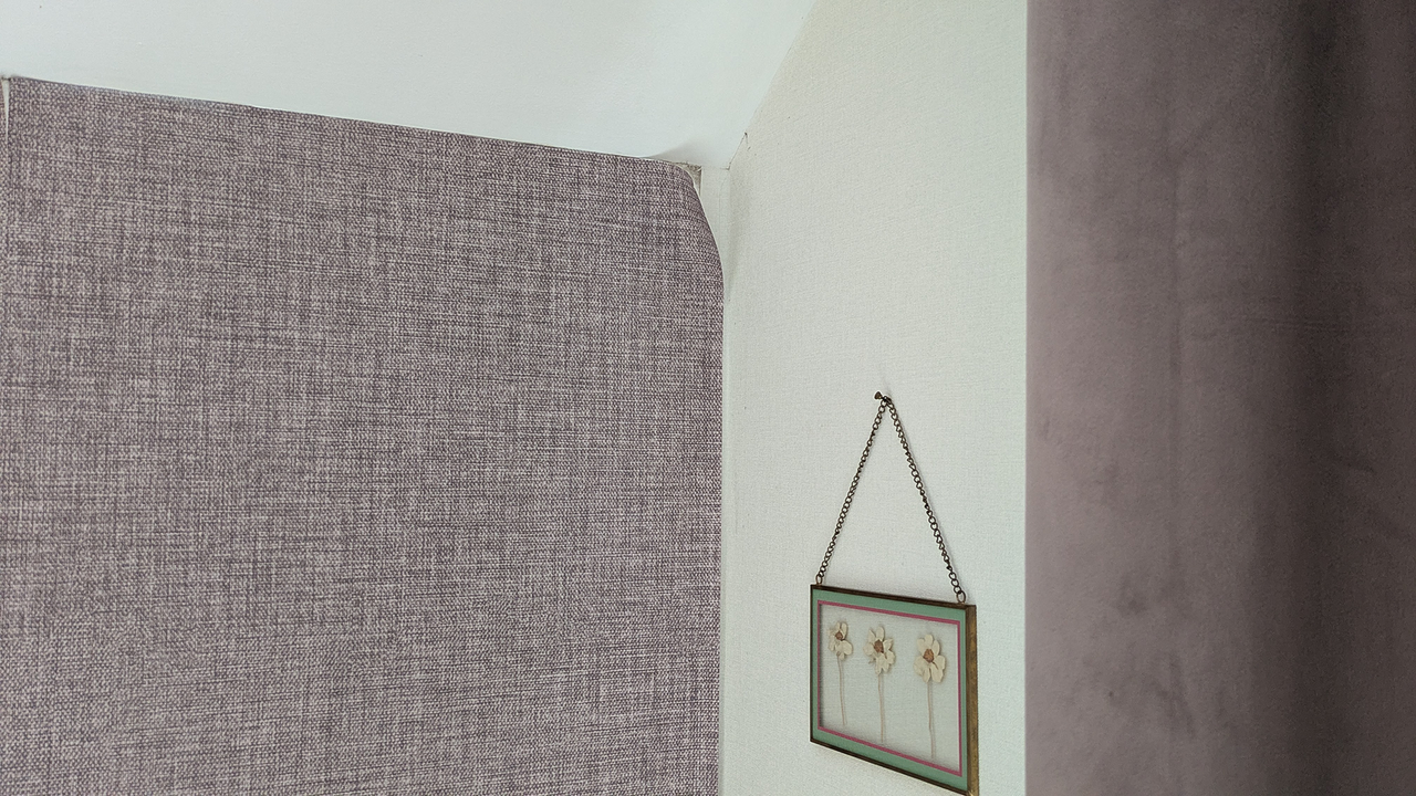 Peeling wallpaper with mold showing