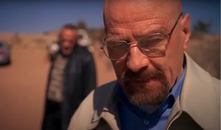 Bryan Cranston glares angrily in the desert in Breaking Bad.