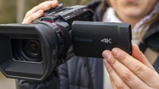 The Panasonic HC-X1500 camcorder in a female photographer's hands