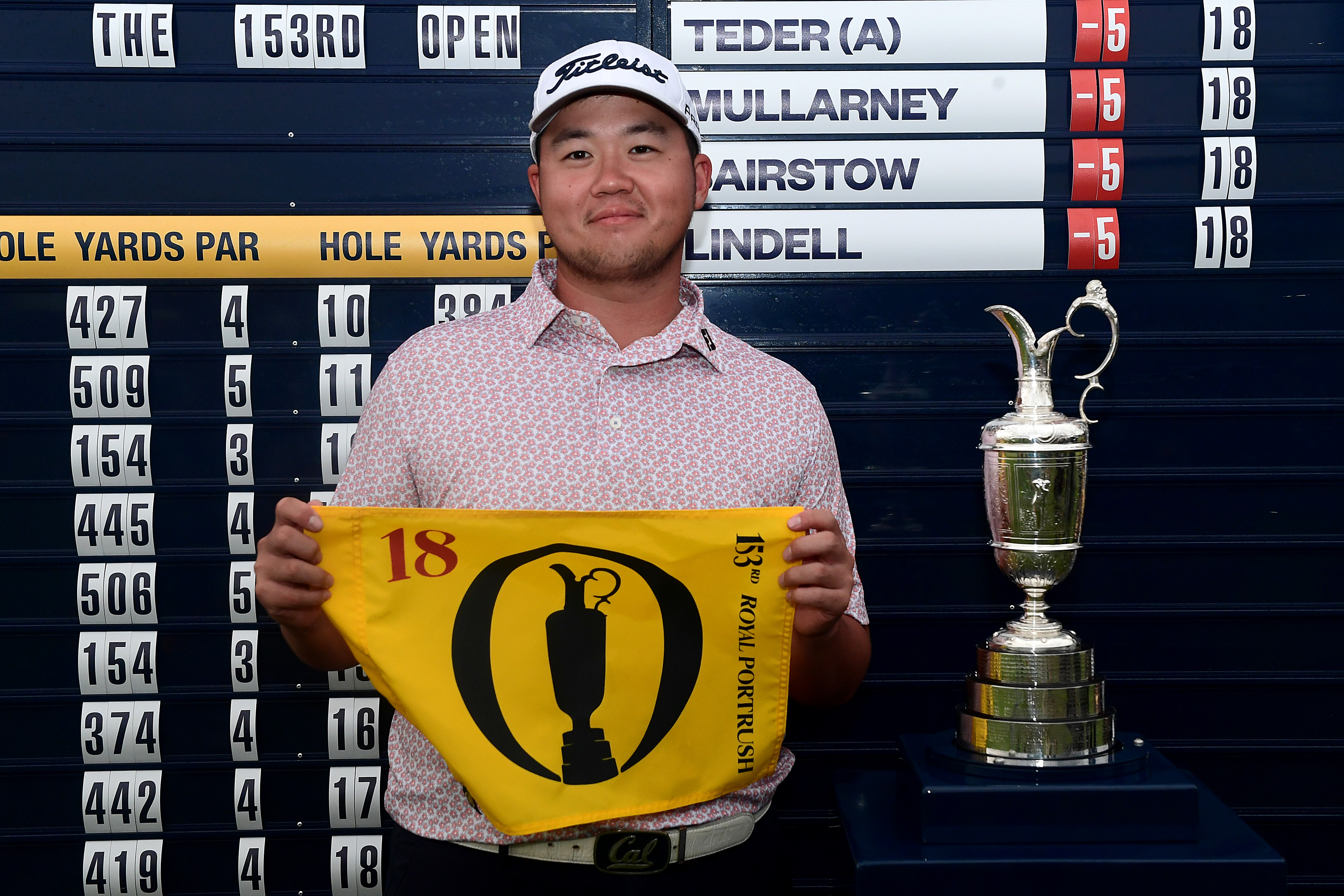 Sampson Zheng holds up his Open Championship pin flag at West Lancashire Golf Club after qualifying for The 153rd Open