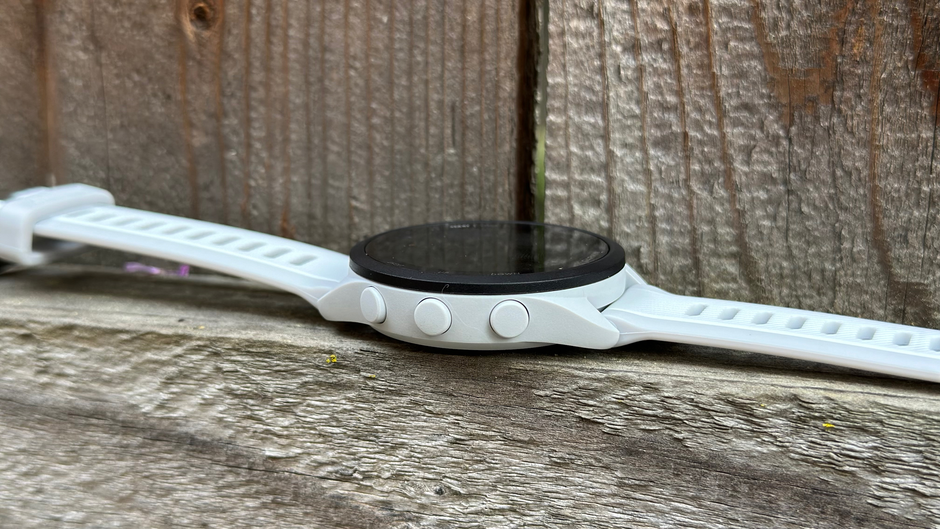 A side view of the three buttons and plastic-looking design of the Garmin Forerunner 165.