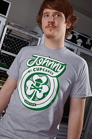 Male model wearing grey and green Shamrock-inspired Johnny Cupcakes t-shirt