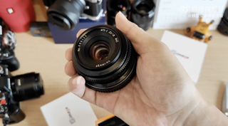 SG-Image lens held in a hand