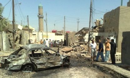 Iraqis inspect the site of a car bomb attack in Ramadi, Iraq, on 25 August 2010.