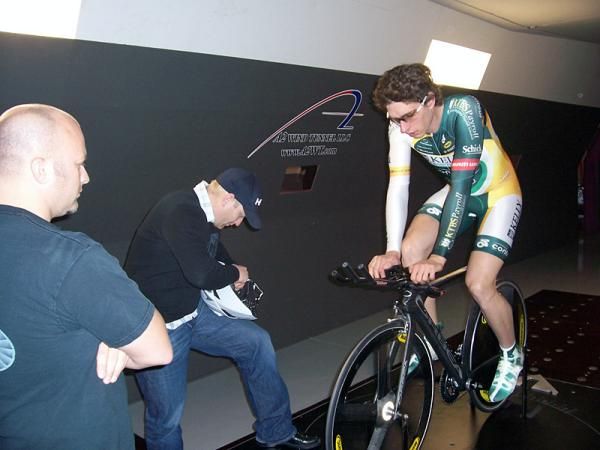 Chris Edin, center, makes an adjustment to Scott Zwizanski's Lazer helmet.