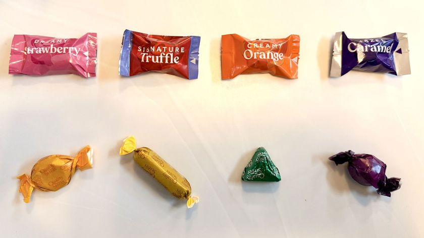 row of roses chocolates above row of quality street chocolates, the latter ones are in shapes the former are in the same packaging shape as each other