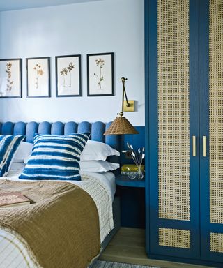 bedroom with blue scalloped headboard and blue and rattan wardrobe in Victorian mews house in London with contemporary interior designed by Kitesgrove
