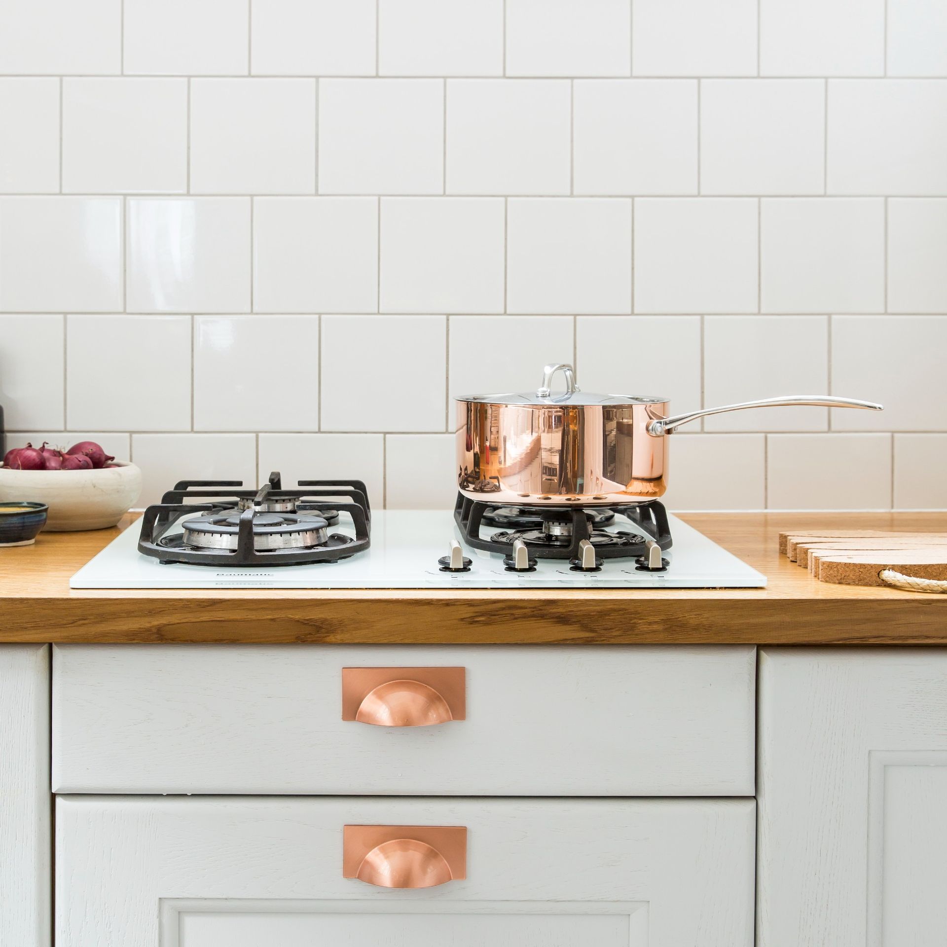A stove with a copper pot on top