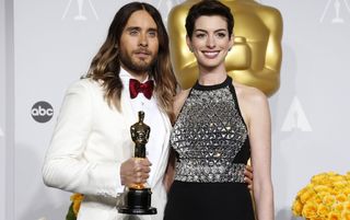 Jared Leto and Anne Hathaway standing together at an awards show.