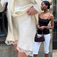 A woman in a white silk skirt. Another woman wearing white capris and a black tank top. 