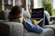 Female on a sofa trading