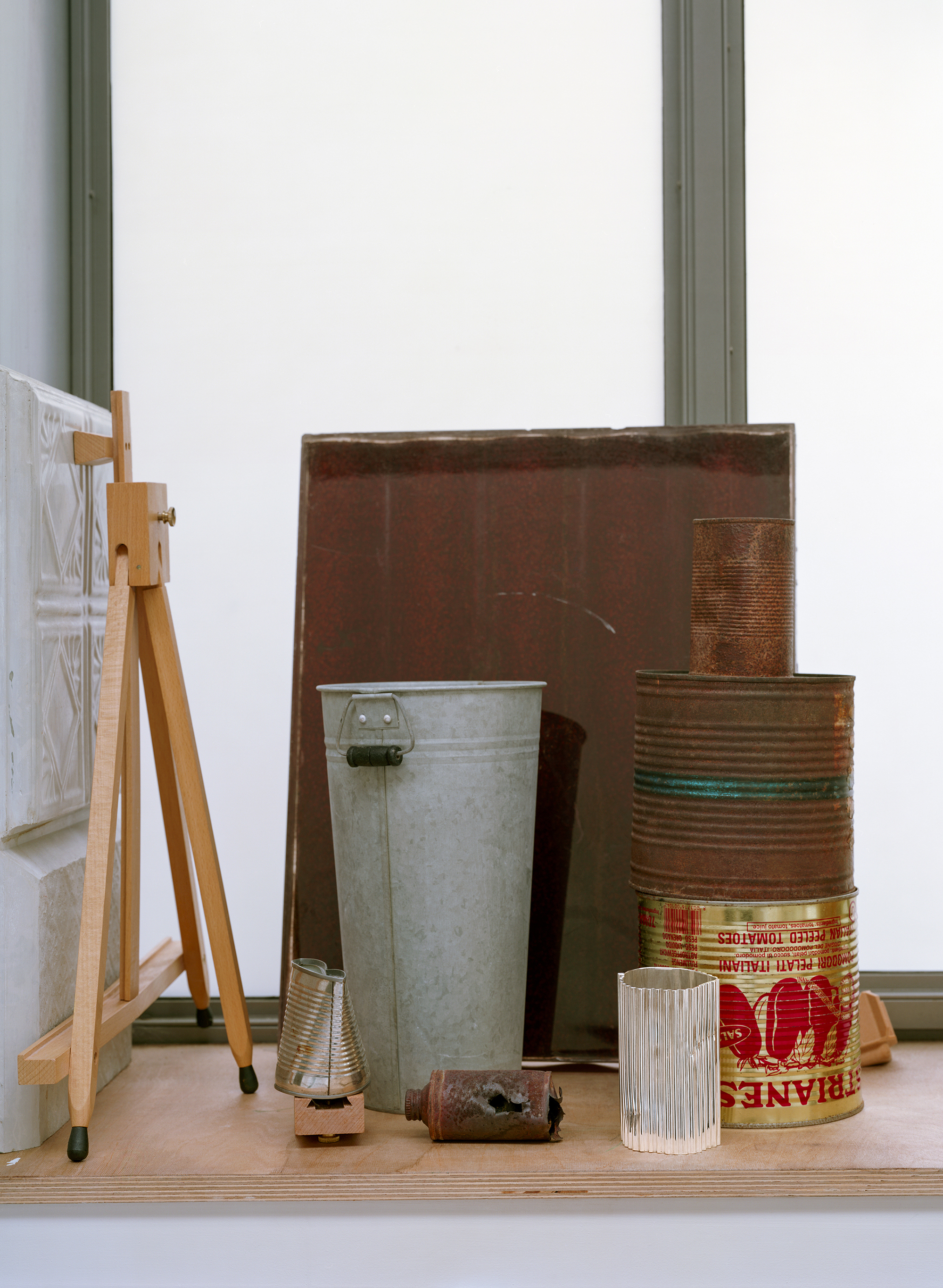 Silver objects with a ridged surface, shown in the context of a messy artist&#039;s studio