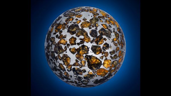 A portion of the Seymchan meteorite from Siberia was ground into a gem-studded metal sphere.